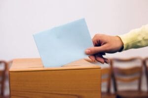 a young woman gives off in an election vote. ballot at the polling station.